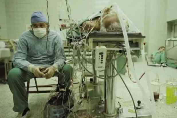 Picture of a heart surgeon Dr. Religa after a 23-hour-long (successful) heart transplant. His assistant is sleeping in the corner. | MirrorLog